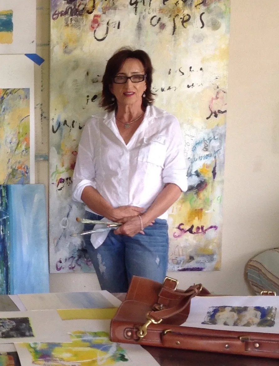 Michele Zuzalek standing in front of a large painting in her studio